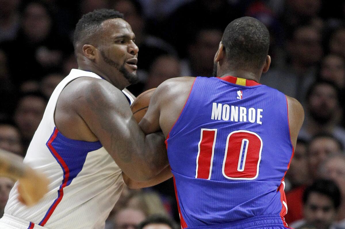 Clippers forward Glen "Big Baby" Davis, left, ties up the ball with Detroit forward Greg Monroe during a Dec. 15 game at Staples Center.