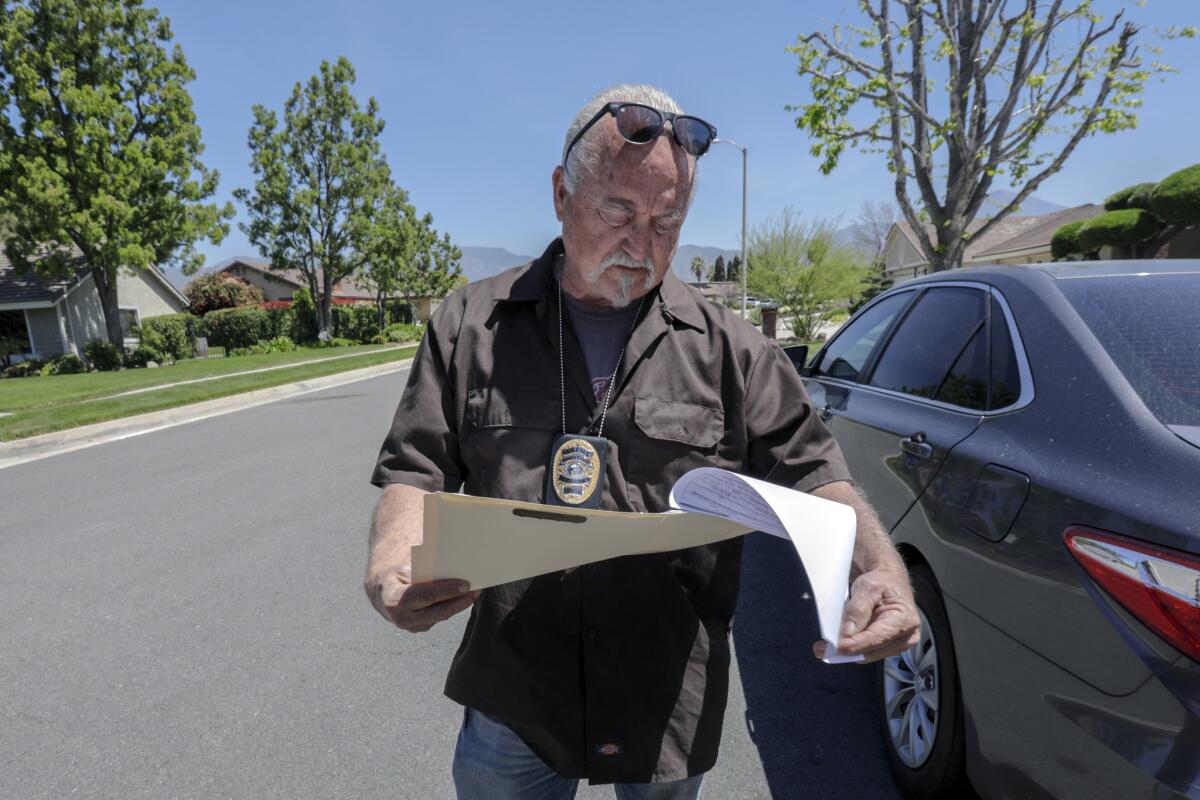 Investigator Marc Bender, a recovery agent for Aladdin Bail Bonds, looks for a person in Redlands who failed to appear for a scheduled court date.