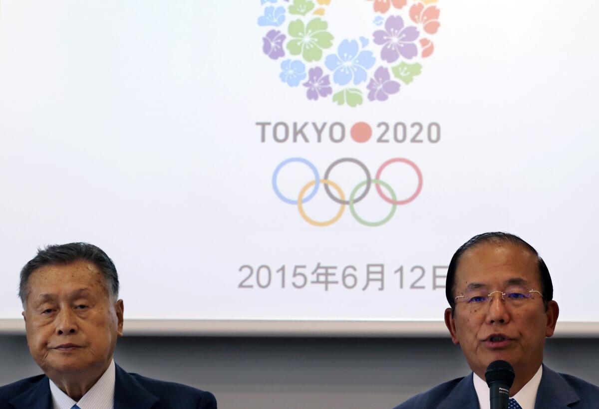 Tokyo 2020 Olympics CEO Toshiro Muto, right, speaks as Tokyo 2020 Olympics President Yoshiro Mori listens during an executive board meeting on Friday.