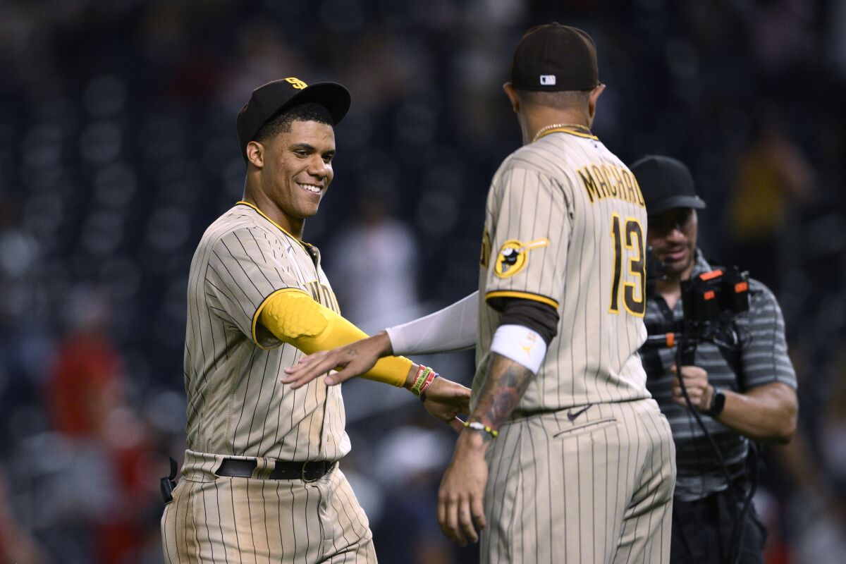 Juan Soto and Manny Machado celebrate the padres' 10-5 victory over the nationals.