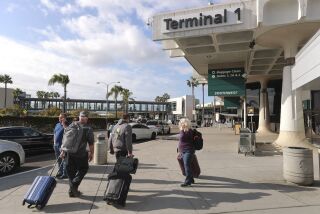 Travelers walk toward Terminal 1 at the San Diego International Airport on Thursday, January 9, 2020 in San Diego, California.