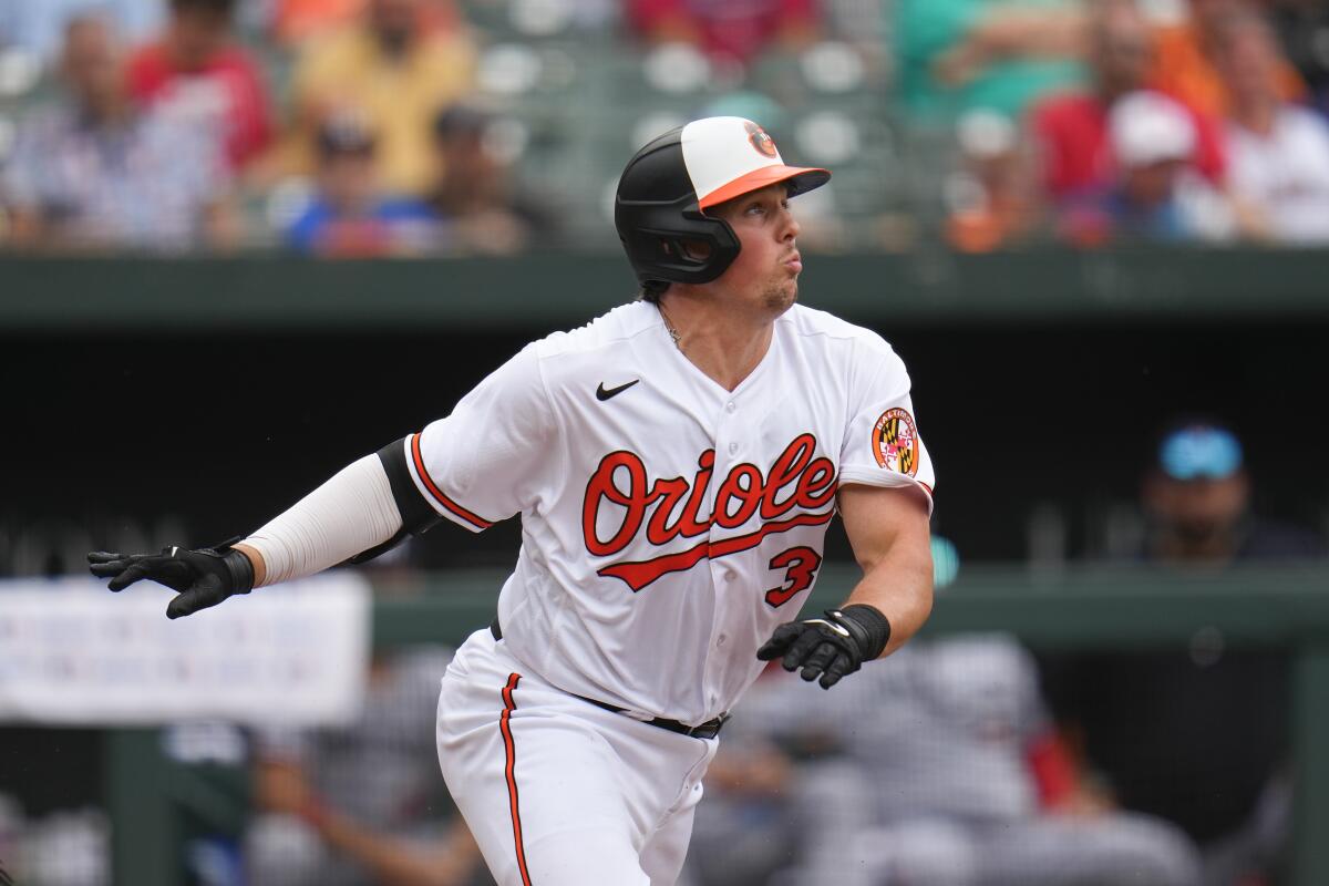 Baltimore Orioles catcher Adley Rutschman throws to first in a