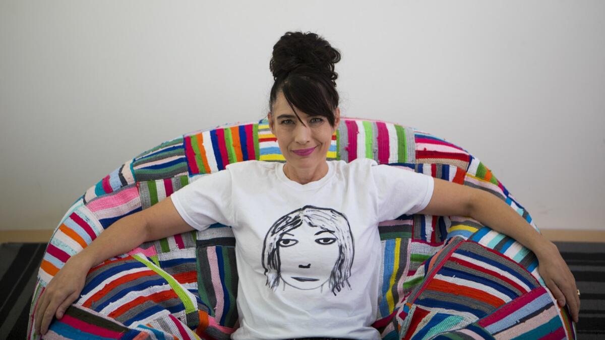 Kathleen Hanna sporting a T-shirt of Kim Gordon's face from her Tees 4 Togo line.