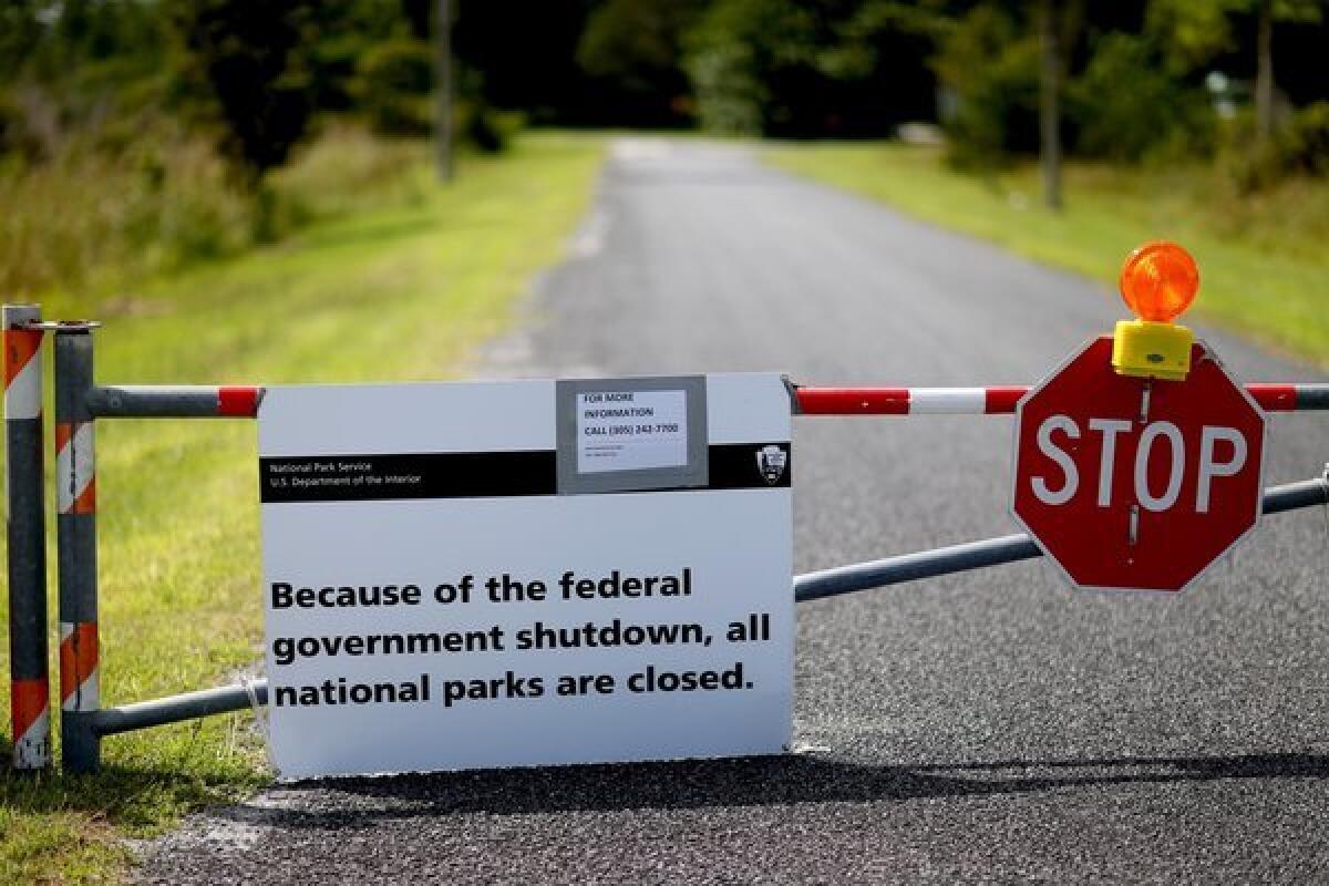 A sign informs visitors that a road leading to Everglades National Park in Florida is closed because of the federal government shutdown. Candidates for local races in many states -- Democratic and Republican alike -- are working to distance themselves from the battle in Washington as polls show rising public disgust with it.