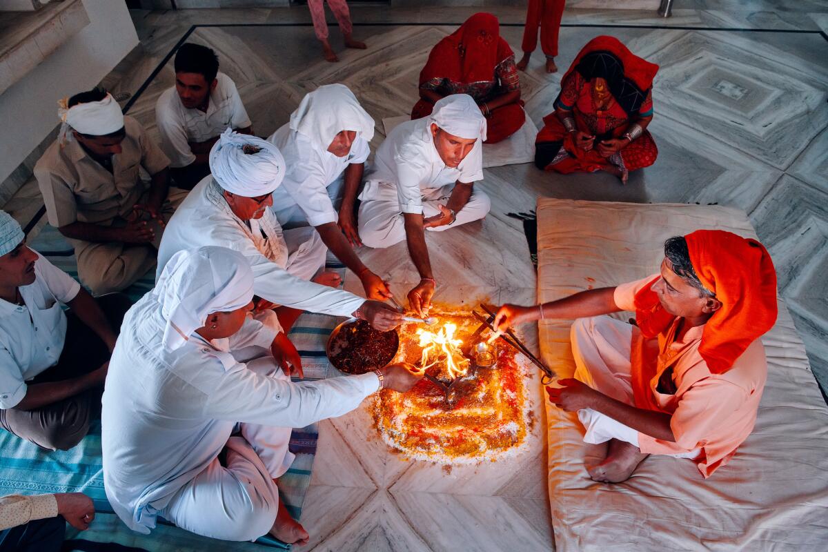 Residents gather for the evening prayer at Hanuman Bishnoi's home in Guda Vishnoiyan village near Jodhpur, India.
