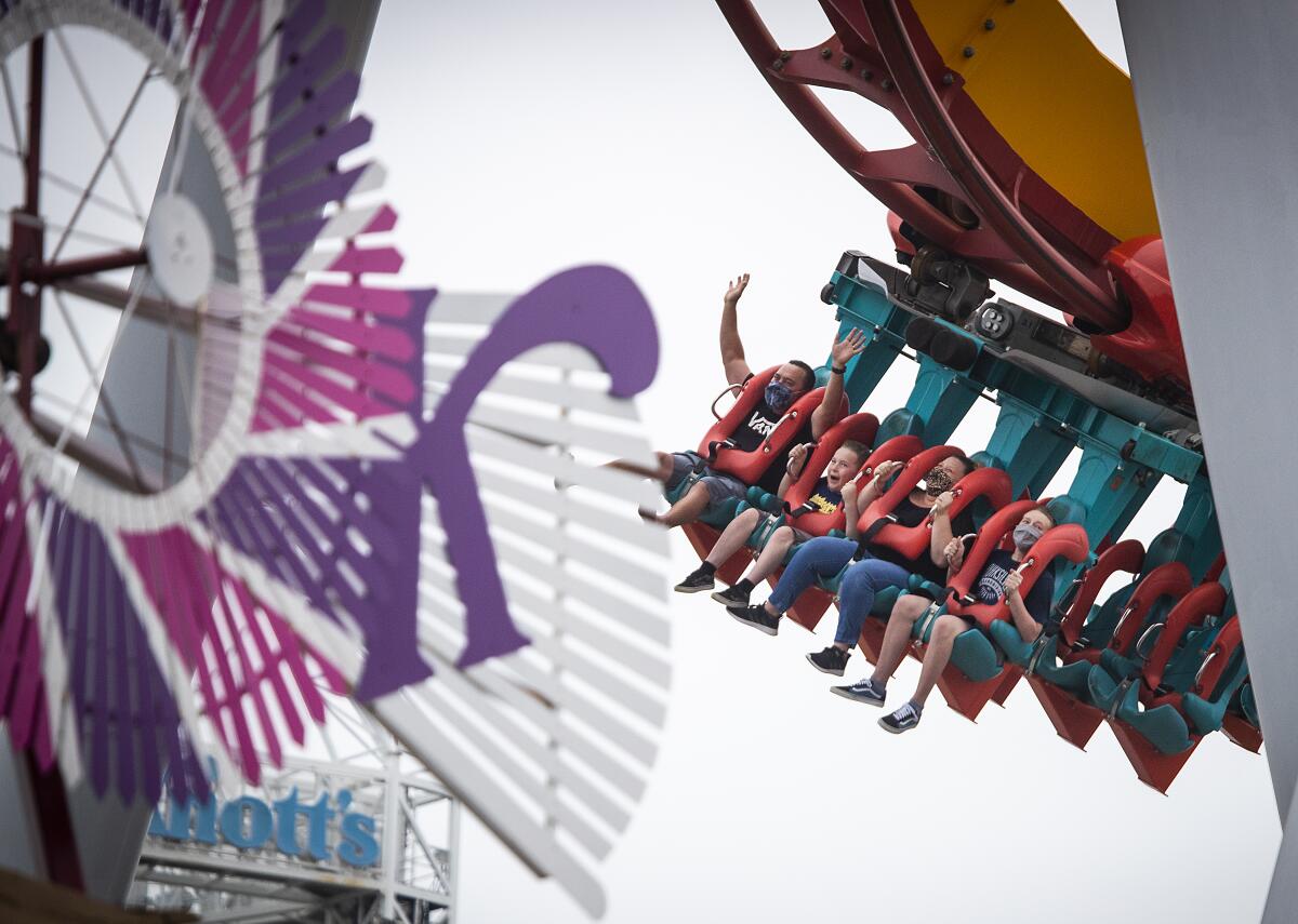 Parkgoers ride the HangTime roller coaster at Knott's Berry Farm.