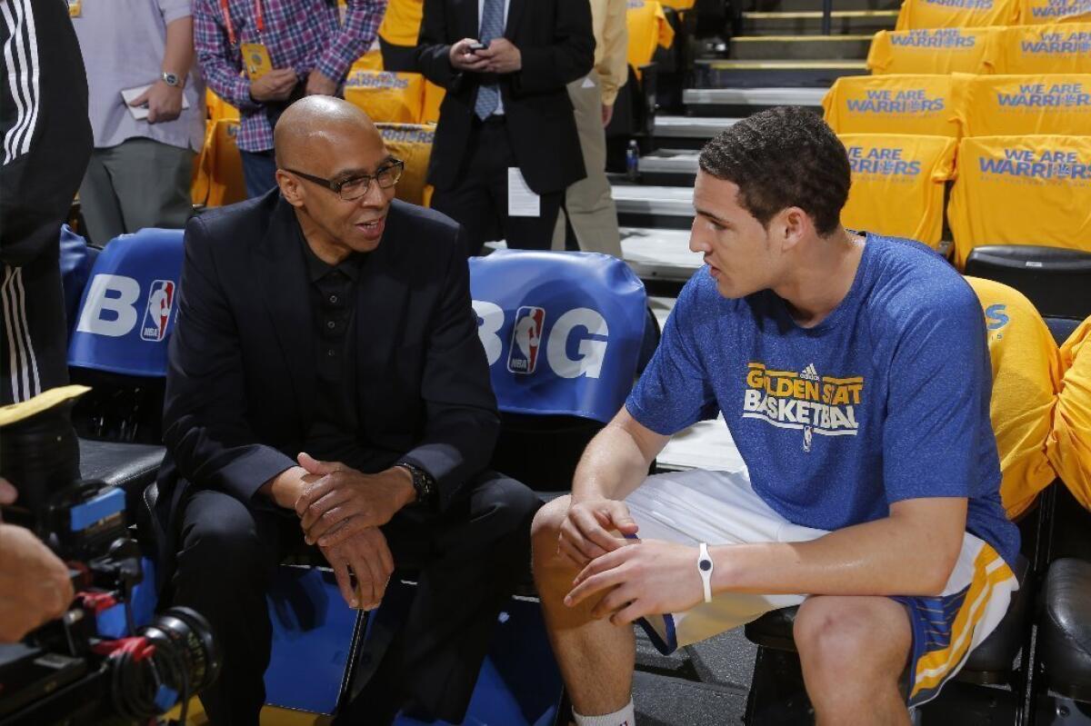 Golden State Warriors Klay Thompson talks with his father Mychal on May 10.