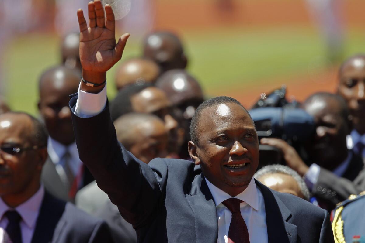 Kenya's Uhuru Kenyatta waves as he arrives at his presidential inauguration ceremony on the outskirts of Nairobi.