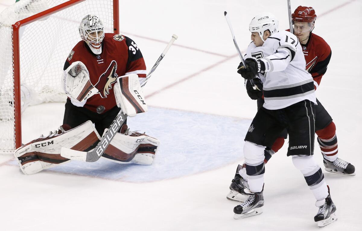 Coyotes goalie Louis Domingue makes a save on a shot as Kings forward Milan Lucic raises his stick in an attempt to redirect the puck during the third period of a game on Jan. 23.