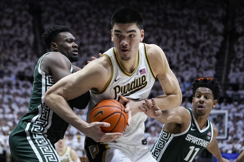 Purdue center Zach Edey (15) moves to the basket between Michigan State center Mady Sissoko (22) and guard A.J. Hoggard (11)during the second half of an NCAA college basketball game in West Lafayette, Ind., Sunday, Jan. 29, 2023. Purdue defeated Michigan State 77-61. (AP Photo/Michael Conroy)