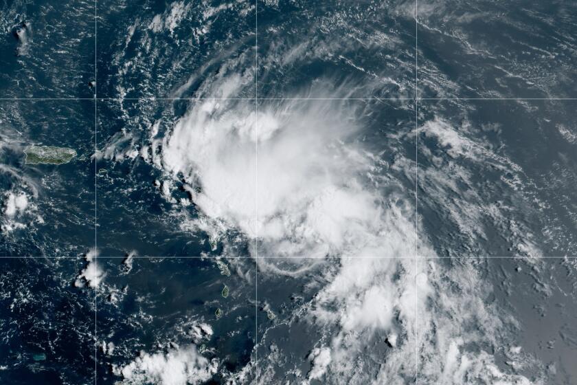 This satellite image released by the National Oceanic and Atmospheric Administration (NOAA) shows Tropical Storm Laura in the North Atlantic Ocean, Friday, Aug. 21, 2020. Laura formed Friday in the eastern Caribbean and forecasters said it poses a potential hurricane threat to Florida and the U.S. Gulf Coast. A second storm also may hit the U.S. after running into Mexico's Yucatan Peninsula. (NOAA via AP)