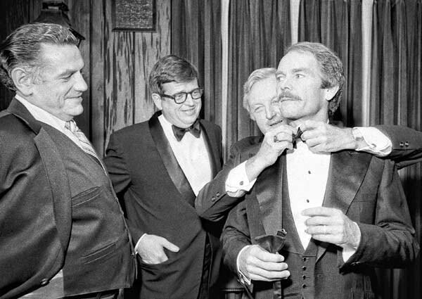 Actor Dean Jones, who plays the part of former Nixon aide Charles Colson in the movie "Born Again," has his tie adjusted at a dinner before the premiere of the movie, Sept. 24, 1978, in Washington. Colson looks on at center with ex-Sen. Harold Hughes who plays himself in the film about Colson's involvement in Watergate and his subsequent conversion to Christianity.