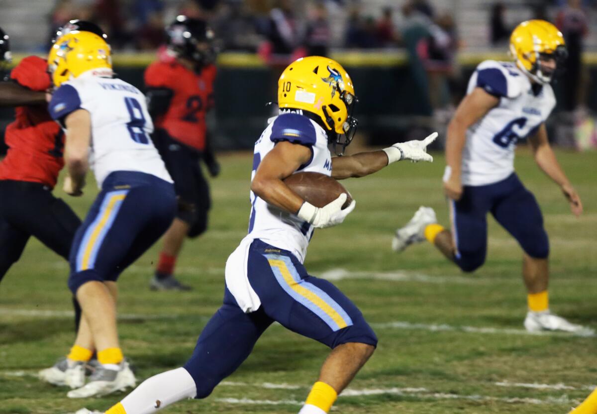 Marina's Luke Lastra (10) returns a punt against Katella in a Big 4 League game at Glover Stadium on Thursday.