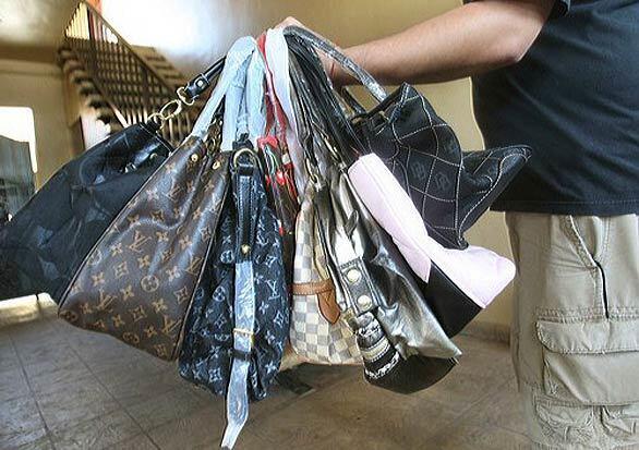 A handful of bags is seized by Investigative Consultants in Lawndale, which is sometimes hired by fashion clients to find counterfeiters.