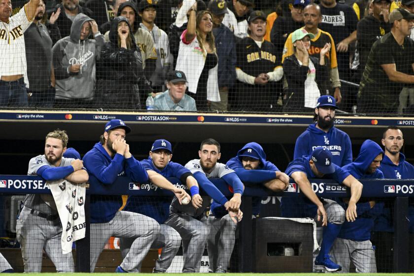 San Diego, CA - October 15: The Los Angeles Dodgers dugout watches during the ninth inning in game 4.