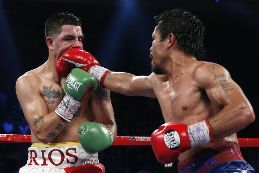 Manny Pacquiao lands a right to the face of Brandon Rios during their WBO international welterweight title fight on Sunday in Macao.