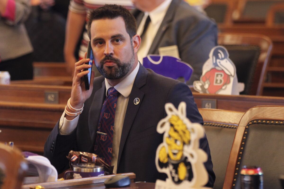 In this photo from Monday, May 3, 2021, Kansas state Rep. Mark Samsel, R-Wellsville, talks on his cellphone ahead of the House's daily session, at the Statehouse in Topeka, Kan. Samsel has surrendered his substitute teacher's license and says he has been seeing mental health professionals after being charged with three counts of battery over interactions with two Wellsville High School students while teaching an April 28, 2021, art class. (AP Photo/John Hanna)