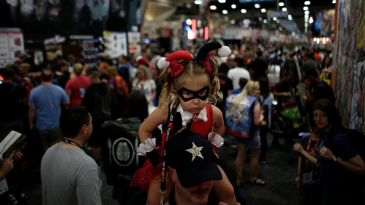 Olivia Hare, 3, as Harley Quinn atop her father Alex's shoulders at Comic-Con International in San Diego on July 20, 2016.