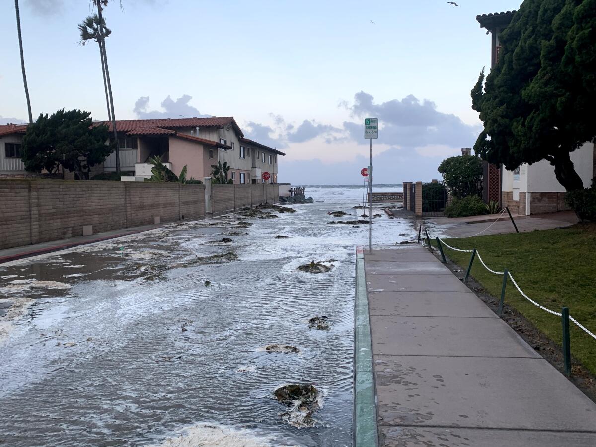 Wind-enhanced flooding Monday at Avenida De La Playa in La Jolla Shores.