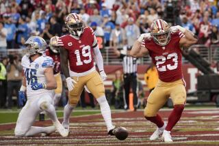 The 49ers' Christian McCaffrey (23) celebrates his touchdown against the Lions.