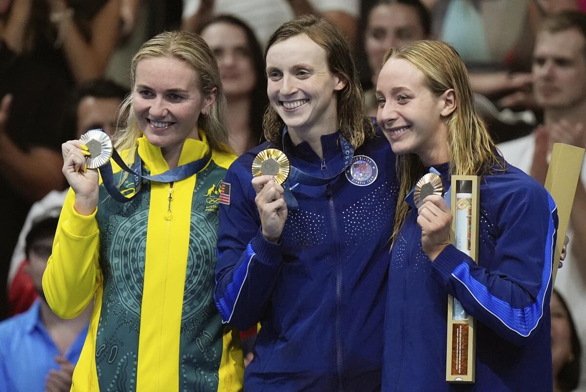 Australia's Ariarne Titmus, the United States' Katie Ledecky and the United States' Paige Madden celebrate with medals