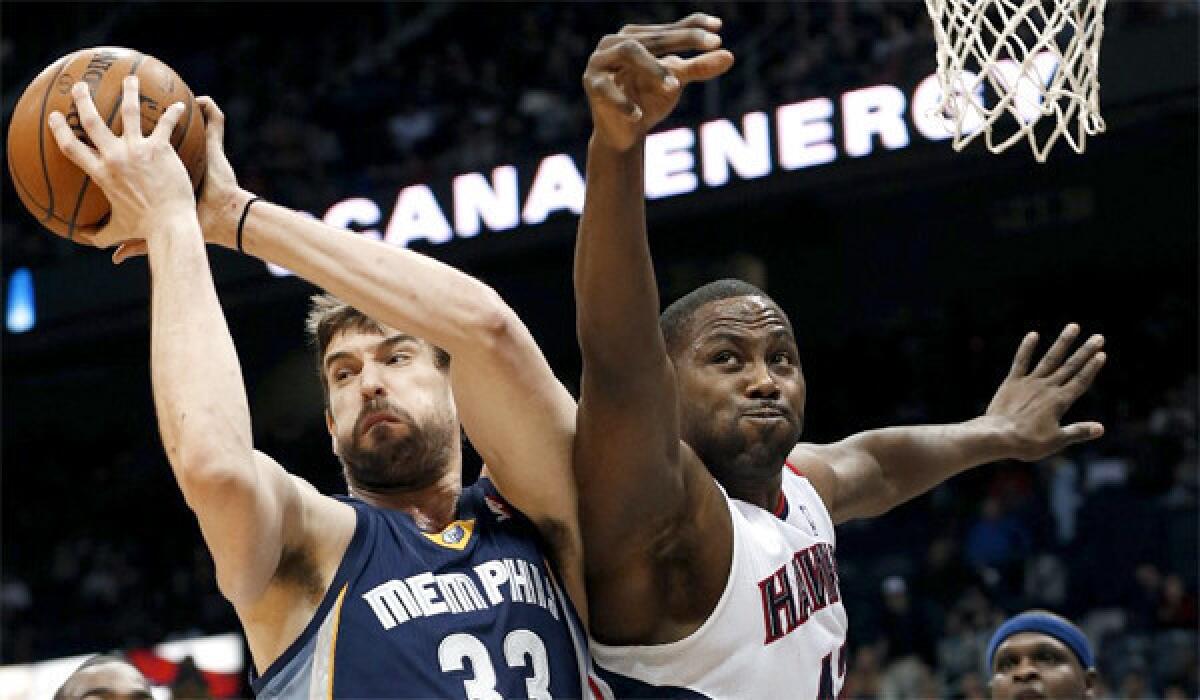 Memphis' Marc Gasol rips a rebound away from Atlanta's Elton Brand during the first half of a game on Feb. 8. Gasol had missed seven weeks because of a knee injury.