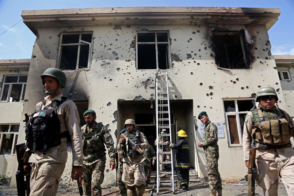 Afghan security personnel surround the area after Taliban fighters stormed a government building in Jalalabad on Monday.