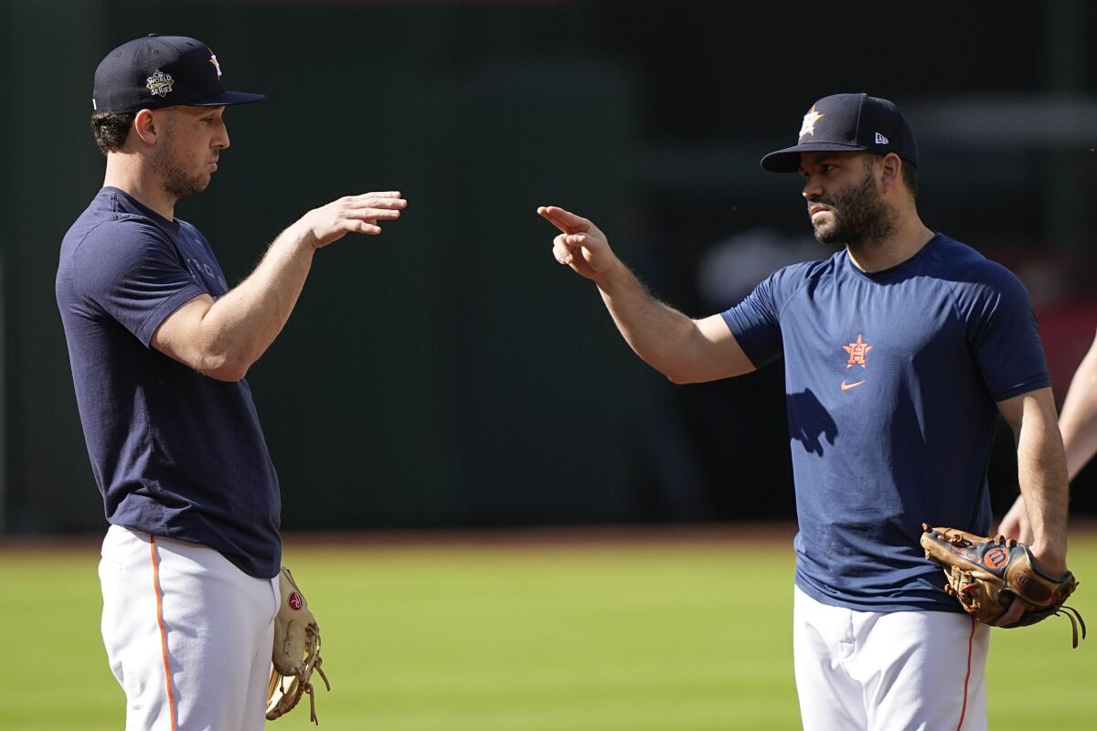 Houston Astros third baseman Alex Bregman and second baseman Jose Altuve speak during batting practice.