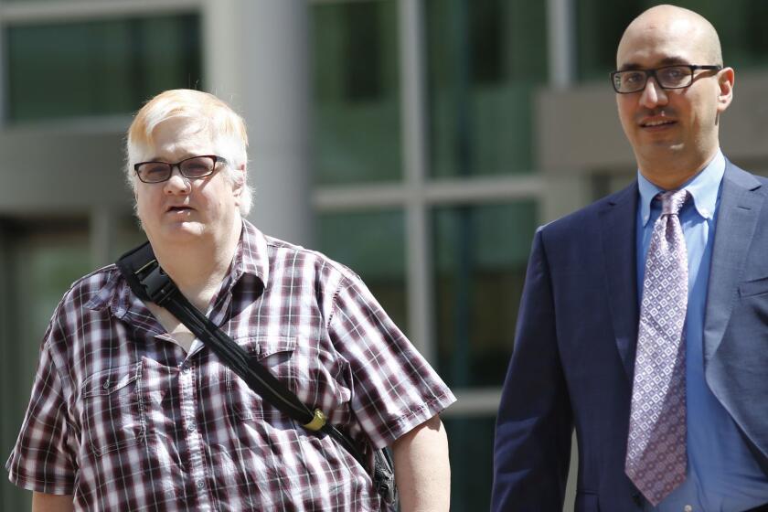 Dana Zzyym, of Fort Collins, Colo., left, and Paul D. Castillo, staff attorney of the South Central regional office of Lambda Legal, emerge after delivering arguments in a hearing on Zzyym's lawsuit requiring people to pick a gender to get a passport in the U.S. Federal Courthouse early Wednesday, July 20, 2016 in Denver. Zzyym, who was born with ambiguous sex characteristics, claims that requiring people to designate their sex to get a passport is discriminatory. (AP Photo/David Zalubowski)