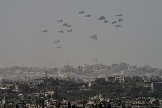 An aircraft airdrops humanitarian aid over the northern Gaza Strip, as seen from southern Israel, Sunday, March 31, 2024. (AP Photo/Tsafrir Abayov)