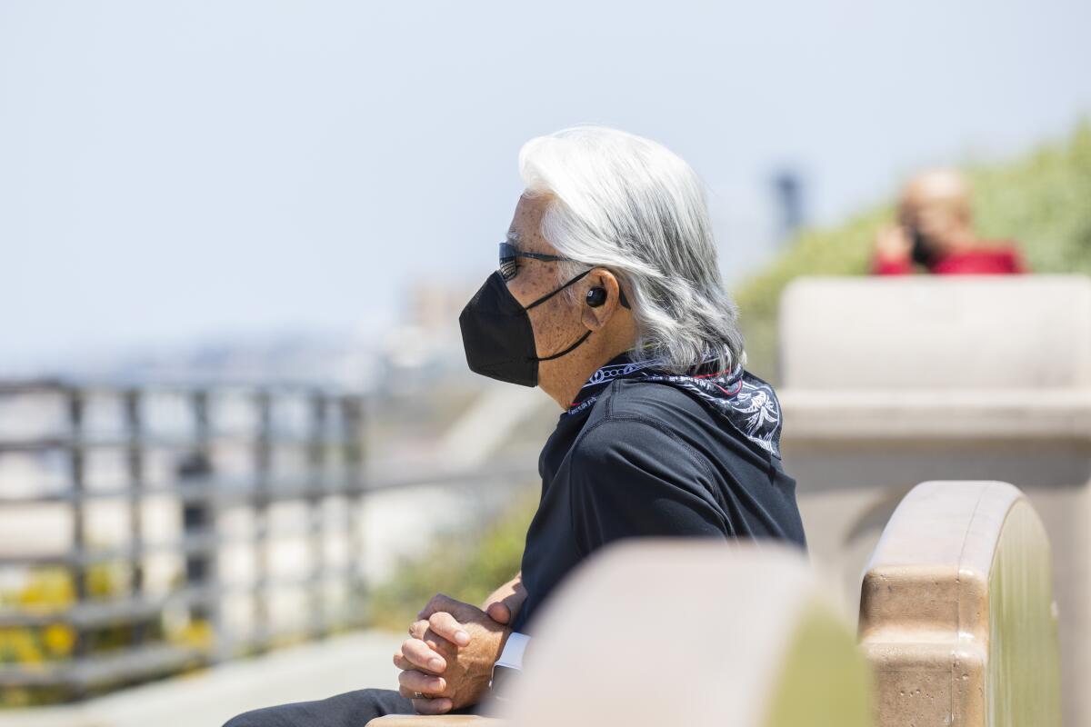  A masked man gazes at the ocean from Miramar Park in Redondo Beach on May 14, 2021. 
