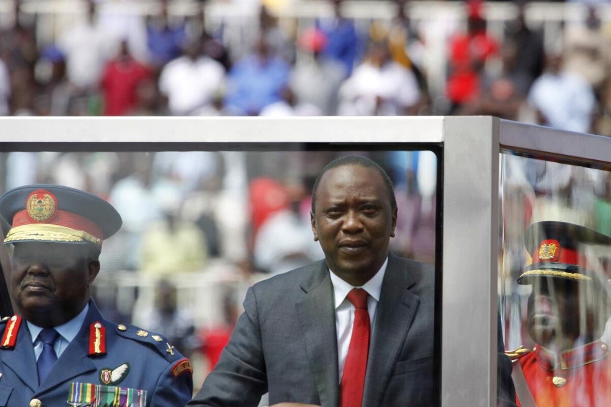 Kenyan President Uhuru Kenyatta, center, shown at a public celebration earlier in the month, denied June 17 that two attacks along the Kenyan coast were carried out by Somali militants, saying instead that local leaders were to blame.