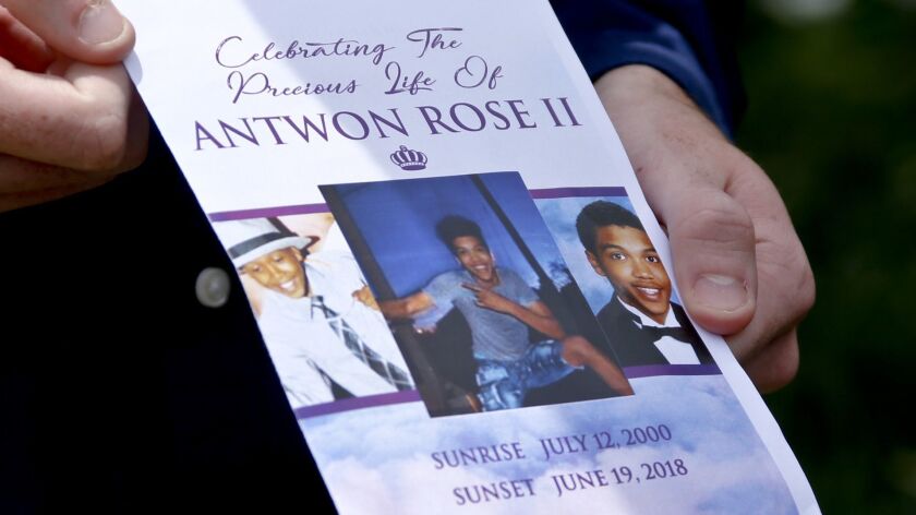 Kyle Fogarty, who said he was a classmate of Antwon Rose Jr., shows the program for Rose's funeral in Swissvale, Pa. Rose was fatally shot by a police officer on June 19.