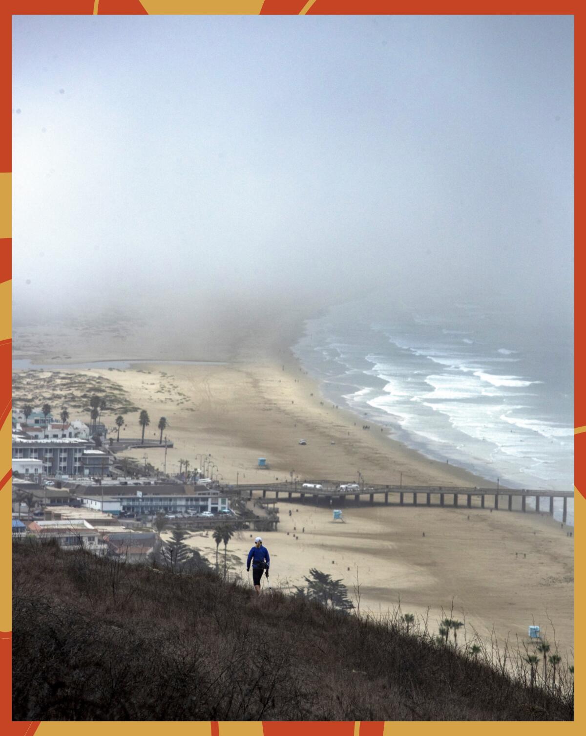 A hiker on the Spring-to-Spring trail overlooking the Pismo Beach pier.