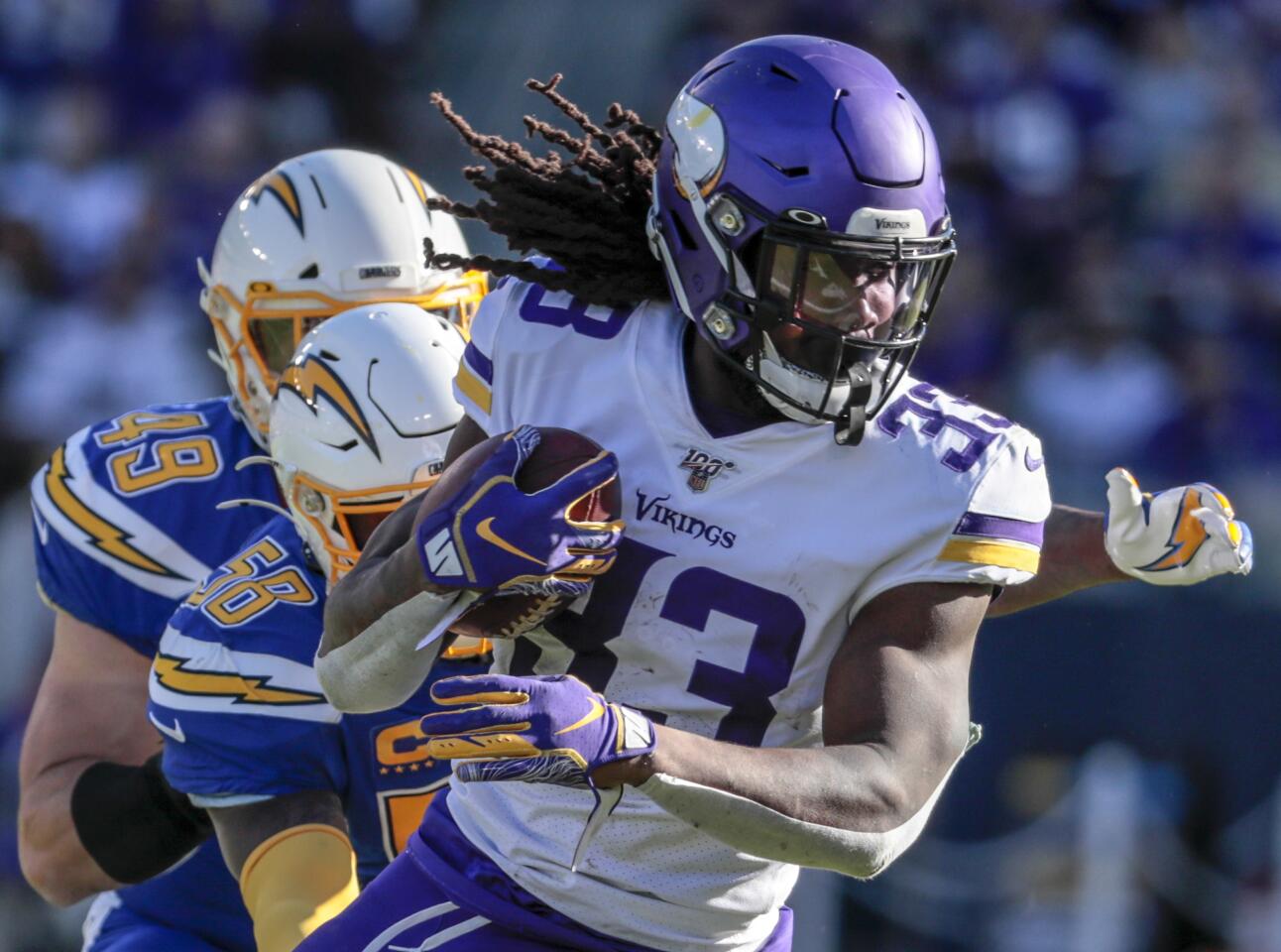 Minnesota Vikings running back Dalvin Cook runs past Chargers outside linebacker Thomas Davis.