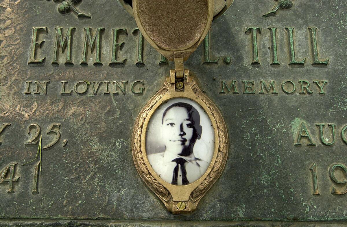 Emmett Till's photo is seen on his grave marker in Alsip, Ill.
