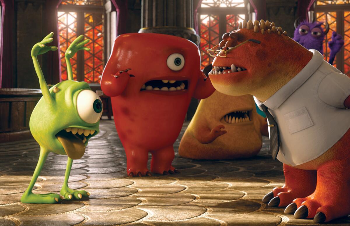 Mike, voiced by Billy Crystal, left, and Professor Knight, voiced by Alfred Molina, right, in a scene from "Monsters University."