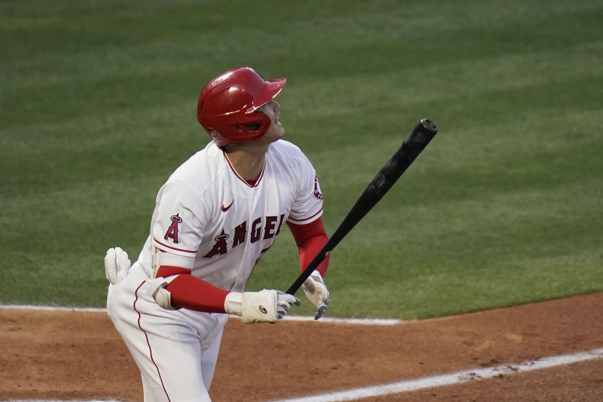 Shohei Ohtani hits a fly ball during the second inning against the Dodgers.