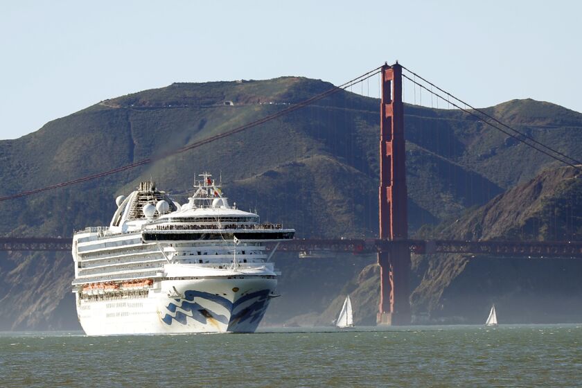 FILE - In this Feb. 11, 2020, file photo, the Grand Princess cruise ship passes the Golden Gate Bridge as it arrives from Hawaii in San Francisco. Scrambling to keep the coronavirus at bay, officials ordered the cruise ship to hold off the California coast Thursday, March 5, to await testing of those aboard, after a passenger on an earlier voyage died and at least one other became infected. (Scott Strazzante/San Francisco Chronicle via AP, File)