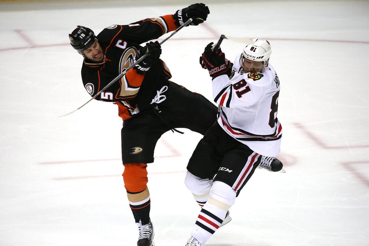 Ducks center Ryan Getzlaf collides with Blackhawks winger Marian Hossain during third period action in Game 1 of the Stanley Cup Western Conference Finals at the Honda Center on Sunday.