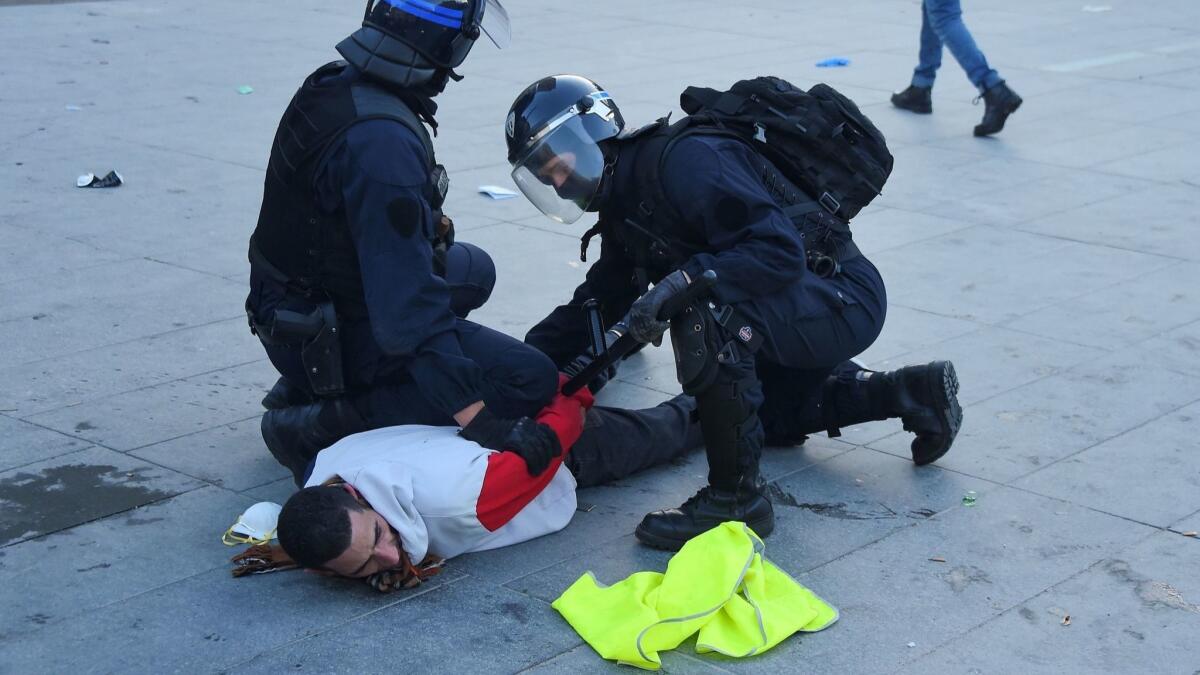 Police forces arrest a protester on Feb. 16, 2019, in Bordeaux, France, during the 14th consecutive week of nationwide "yellow vest" protests against the French president's policies.