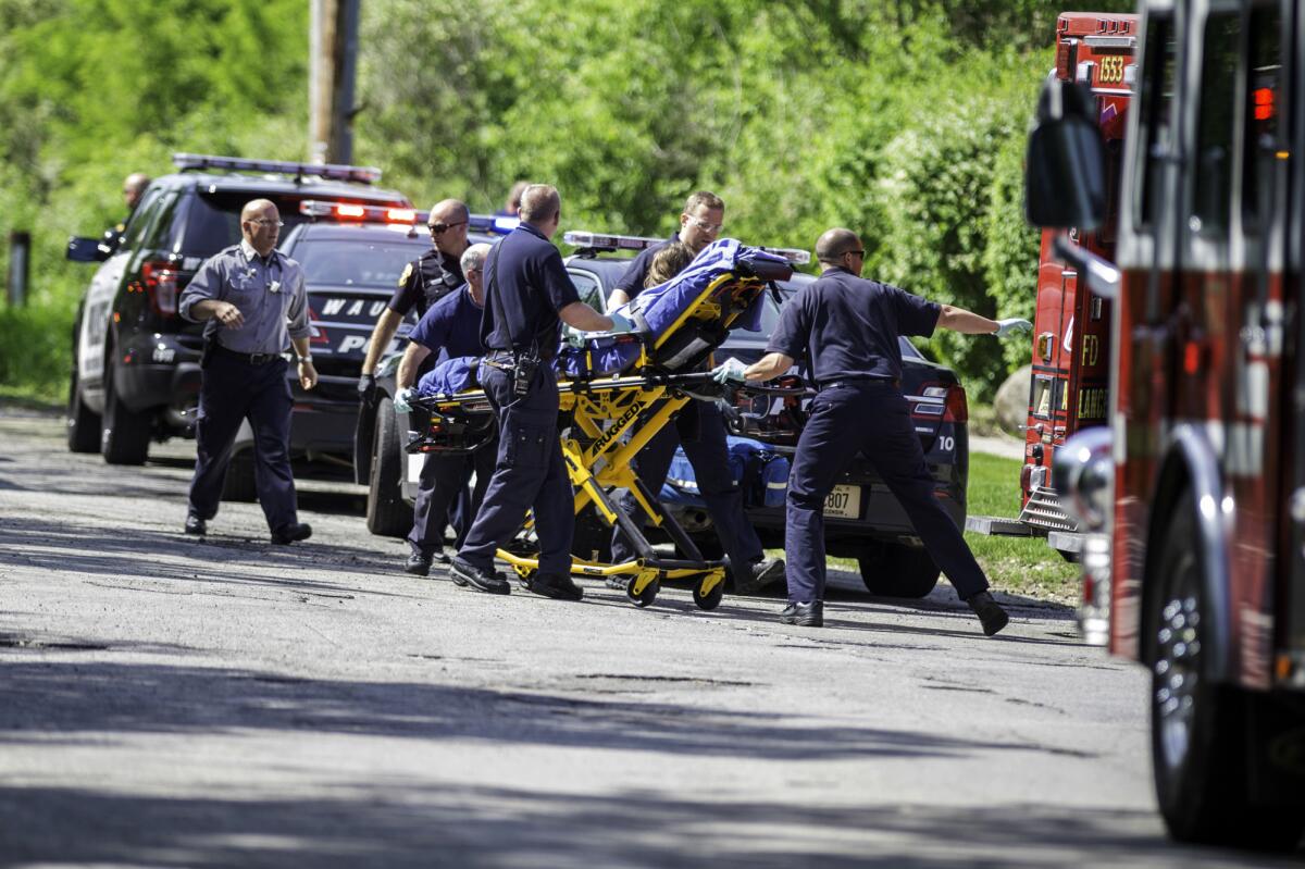 Rescue workers in Waukesha, Wis., take the 12-year-old stabbing victim to an ambulance on May 31. The girl has recovered to the point that she recently attended a movie with her father, according to a statement released by the family on Tuesday