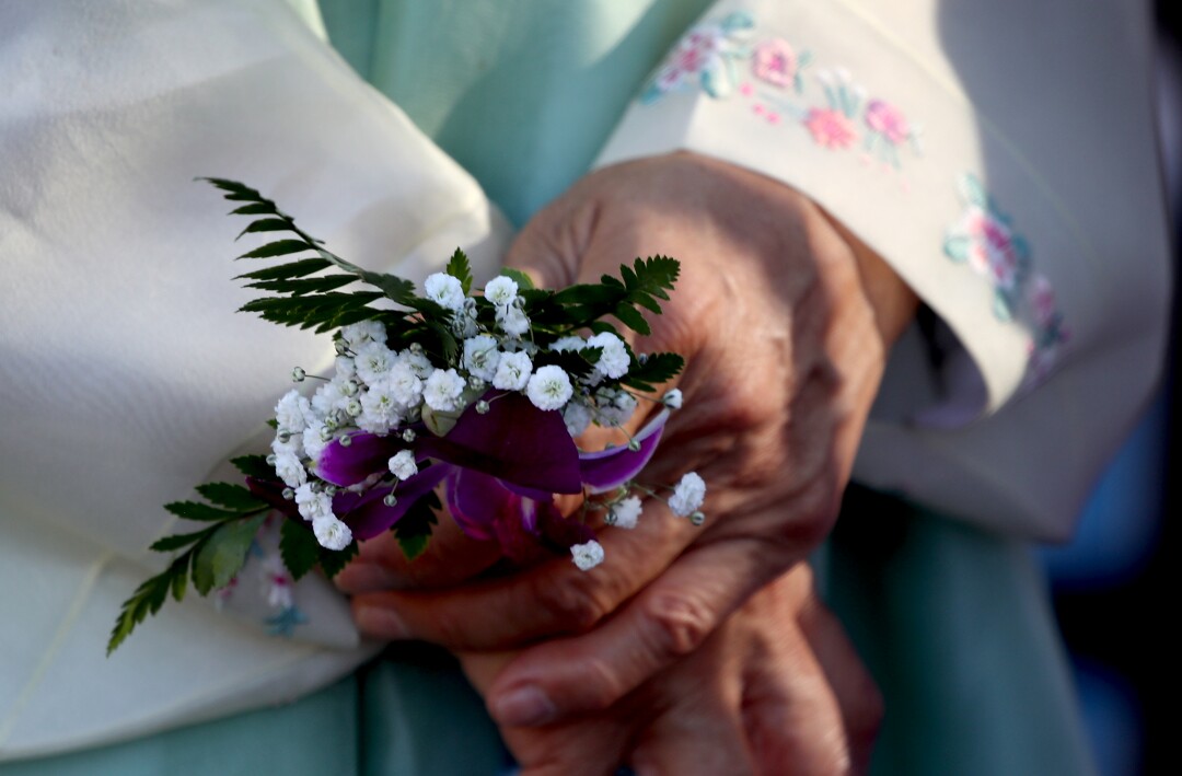 Korean War memorial opens in Fullerton with donations from
Koreans near and far 4 A woman holds flowers and wears a traditional Korean dress during the unveiling of Korean War memorial at Hillcrest Park