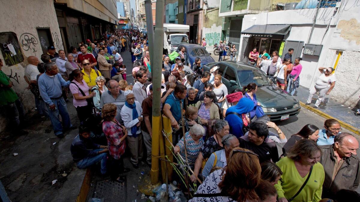 People line up outside a supermarket in Caracas, Venezuela, to buy toilet paper.