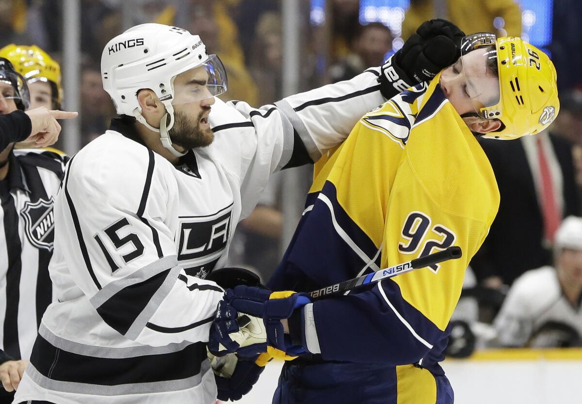 Kings forward Andy Andreoff (15) scuffles with Predators center Ryan Johansen (92) in the first period of their game Saturday night in Nashville.