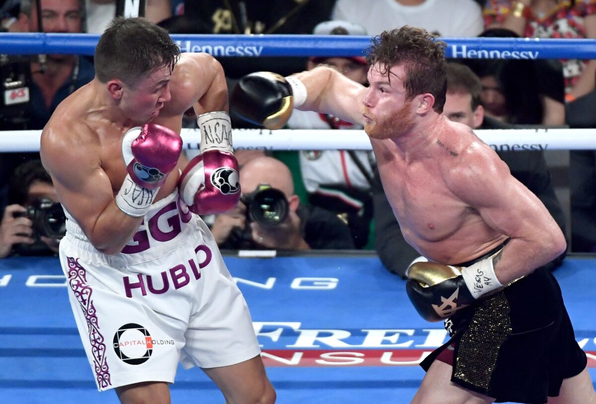 Canelo Alvarez (R) throws a right at Gennady Golovkin in the third round of their WBC/WBA middleweight title fight at T-Mobile Arena on September 15, 2018 in Las Vegas, Nevada. Alvarez won by majority decision.