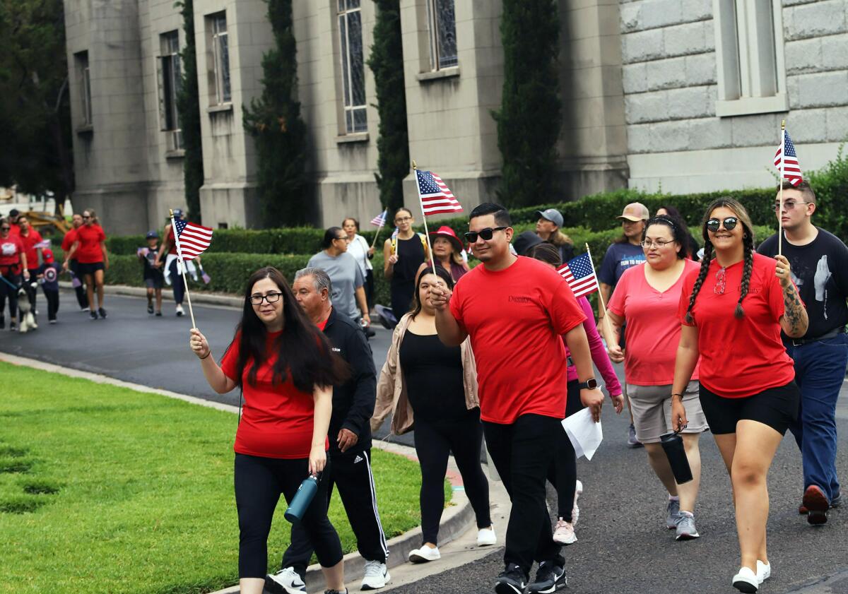 About 50 people take part in walking 2,200 steps around FairHaven Memorial Sunday.