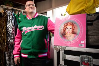 La Mesa, CA - April 26: Matthew Blake, singer-songwriter who performs in drag as Flamy Grant, poses for a portrait with their vinyl record at Blake's home on Wednesday, April 26, 2023 in La Mesa, CA. (Meg McLaughlin / The San Diego Union-Tribune)