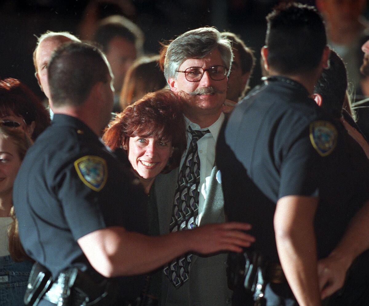 Fred Goldman, center, and his wife, Patti, leaving a courthouse in Santa Monica