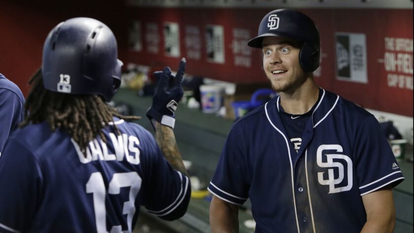Wil Myers and Freddy Galvis in the Padres dugout after his home run in Sunday's 16th inning.